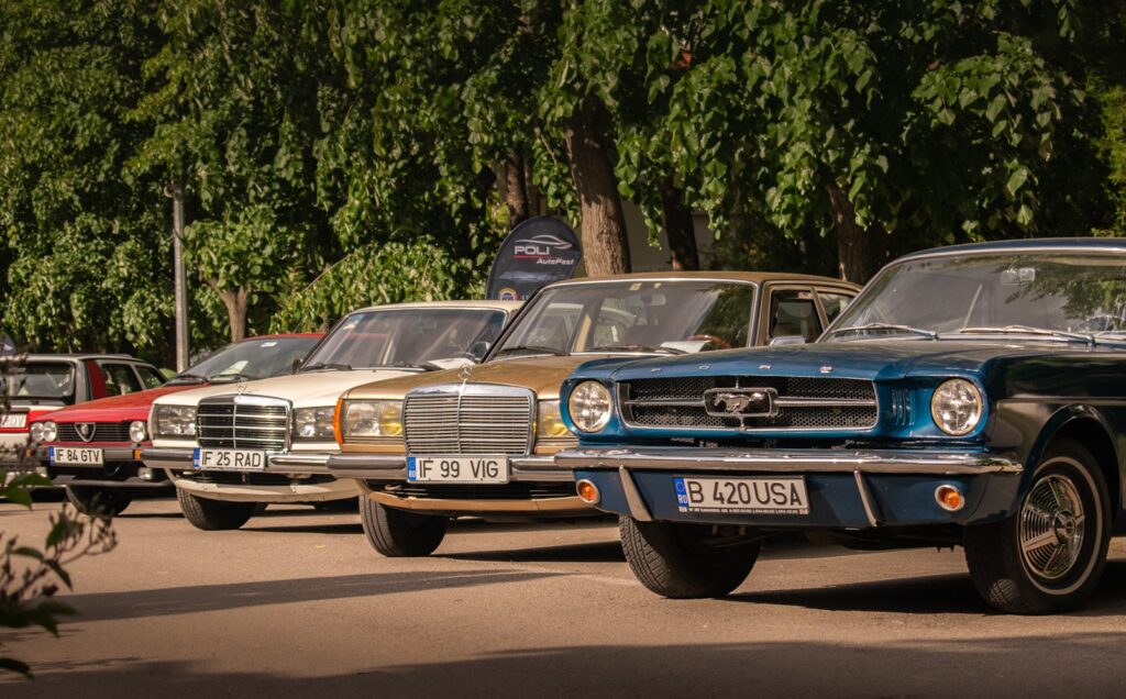 Classic cars are parked in a row.