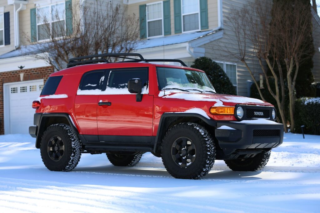 Red suv parked in the snow