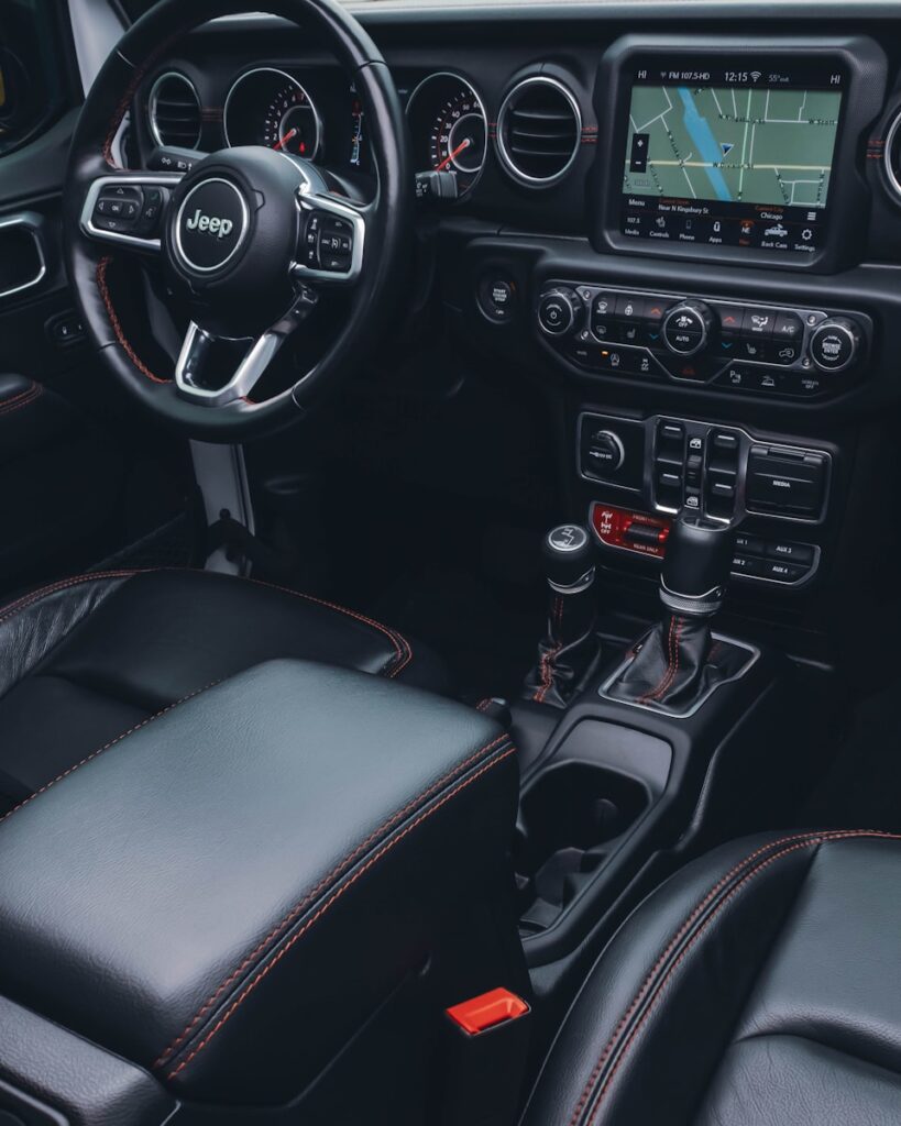 the interior of a car with a steering wheel and dashboard