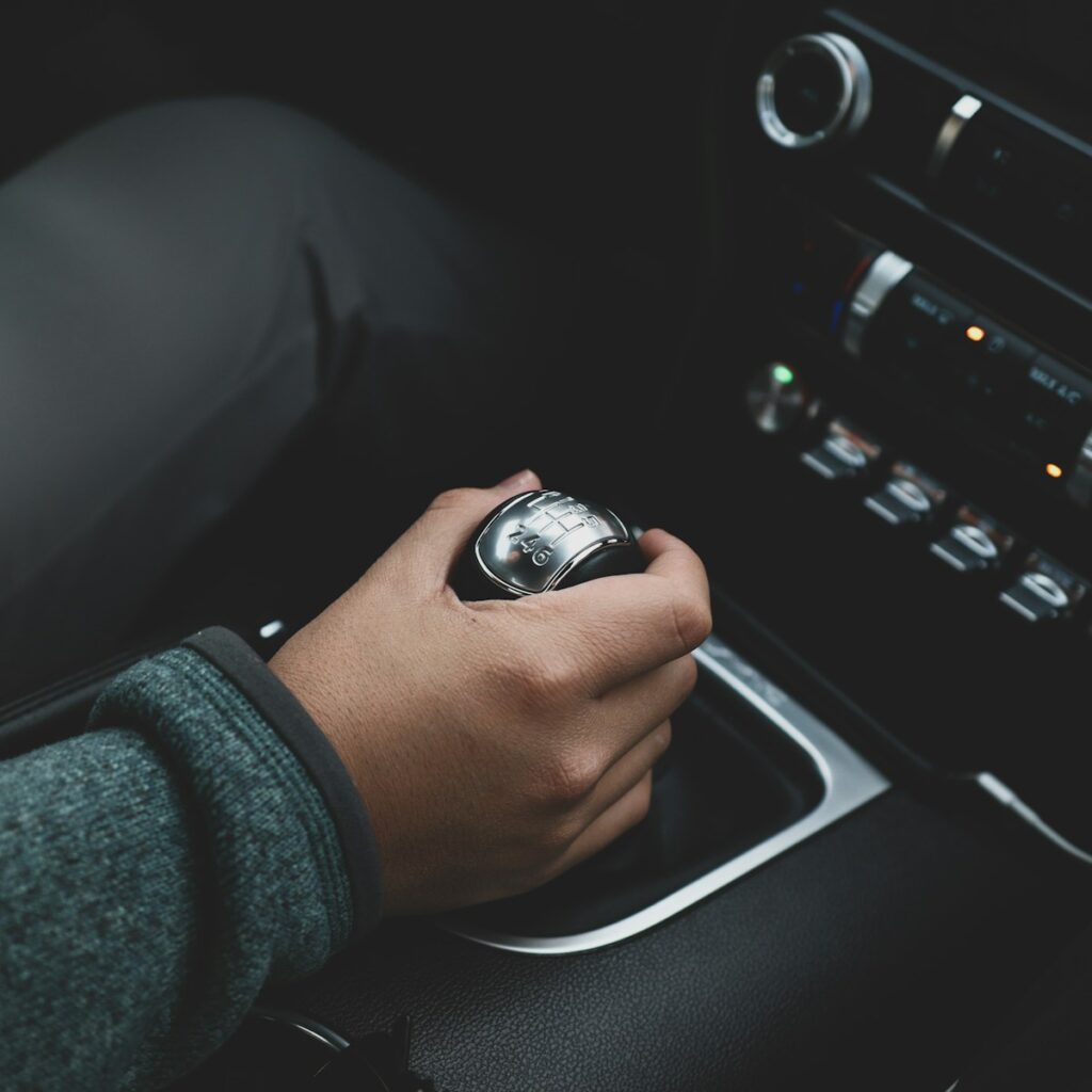 a person is holding a watch while driving a car