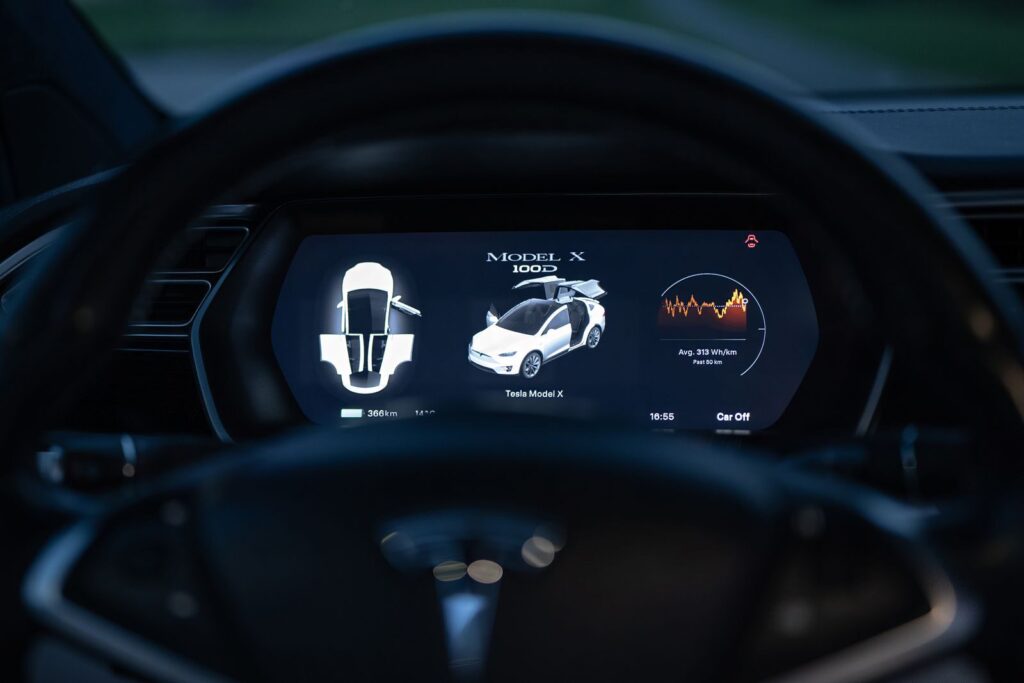 Close-up view of a Tesla Model X dashboard showcasing its digital display and futuristic controls.
