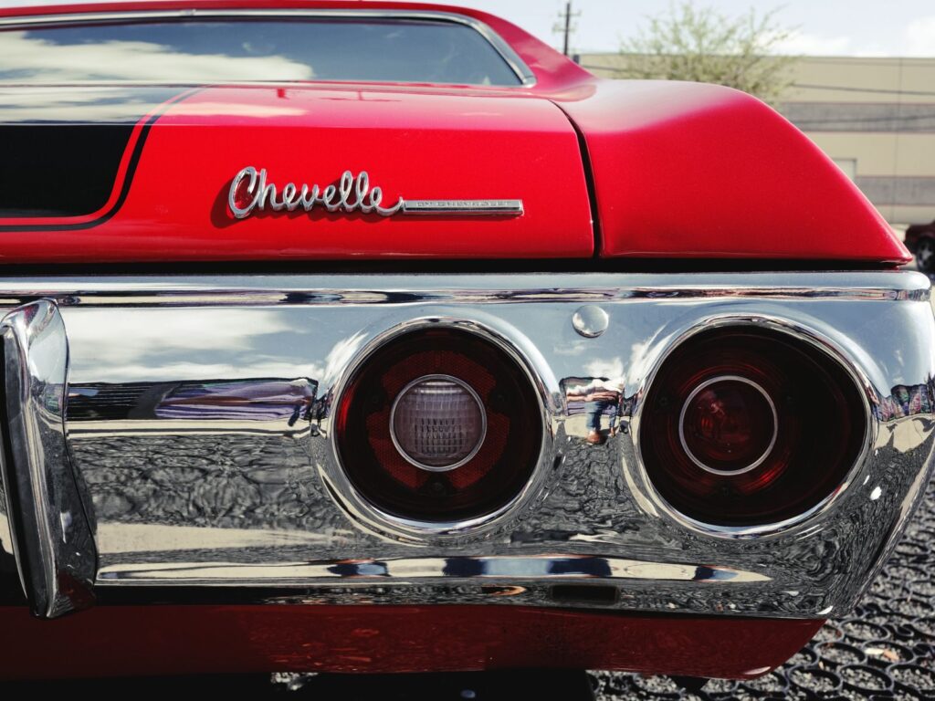 Close-up of the rear view of a red Chevrolet Chevelle with iconic tail lights in Houston, TX.