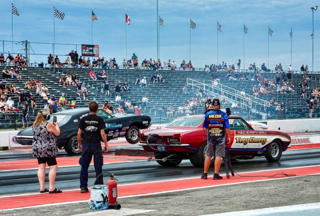 Thrilling drag racing scene in Haldimand, Ontario, with classic cars and a lively crowd enjoying the competition.