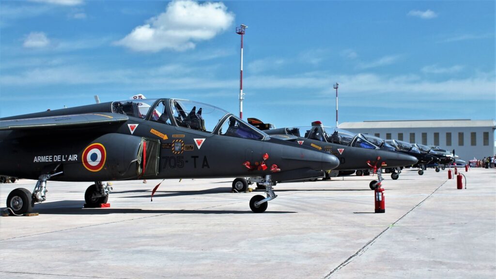 Line of French Air Force jets on a sunny runway in Malta, ready for operations.