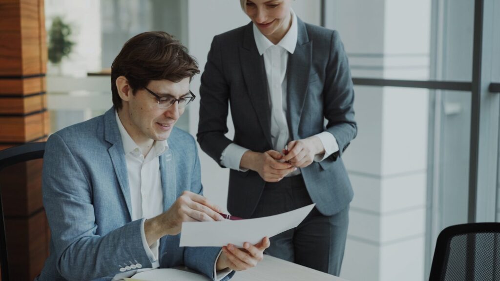 Two business people reviewing documents together