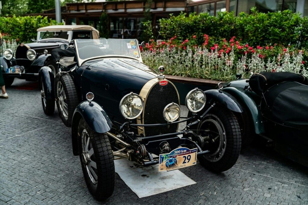 Vintage dark blue convertible car with a license plate.