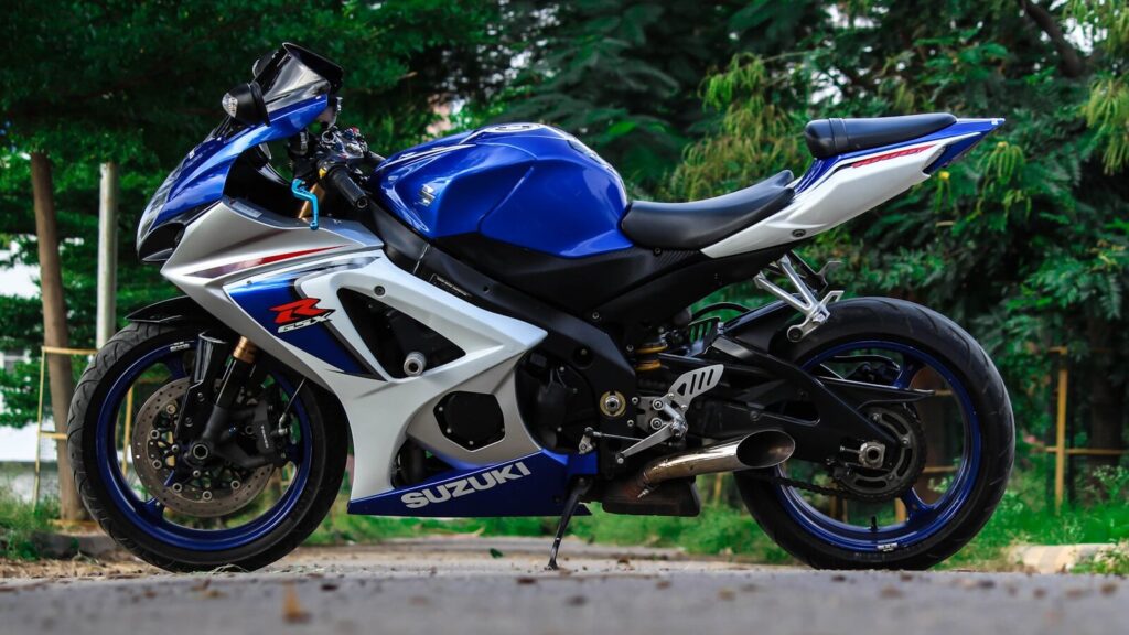 blue and white Suzuki sports bike parked during daytime