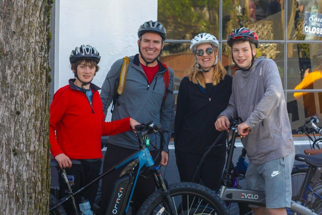 a group of people standing next to each other with bikes