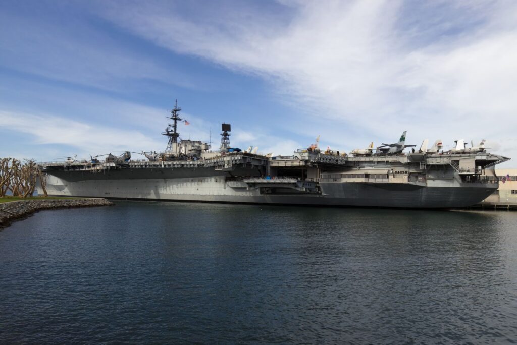 USS Midway aircraft carrier docked in San Diego Harbor, showcasing naval history.