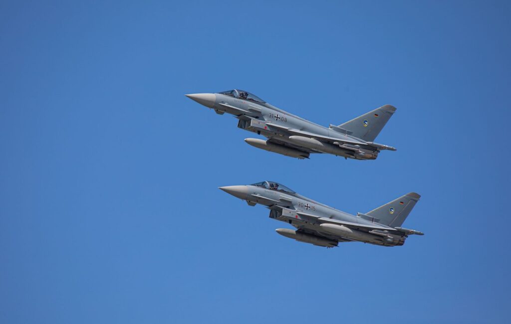 German Air Force Eurofighter Typhoons soaring in clear Slovakian sky.