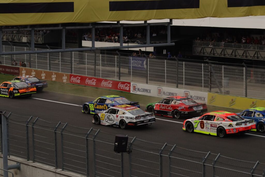 Thrilling NASCAR event at Mexico City with colorful race cars and dynamic action on the track.