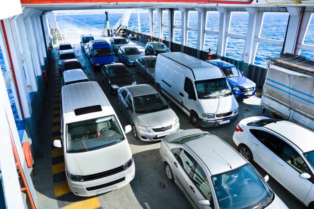 Vehicles onboard a ferry crossing the ocean, showcasing maritime transport and travel.