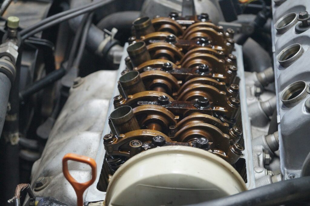 Oily valve train inside an open car engine.