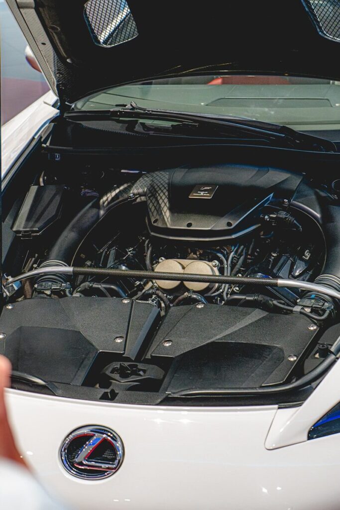 Close-up of a car engine with hood open