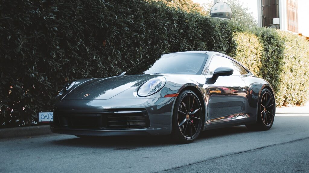 a grey porsche parked on the side of the road