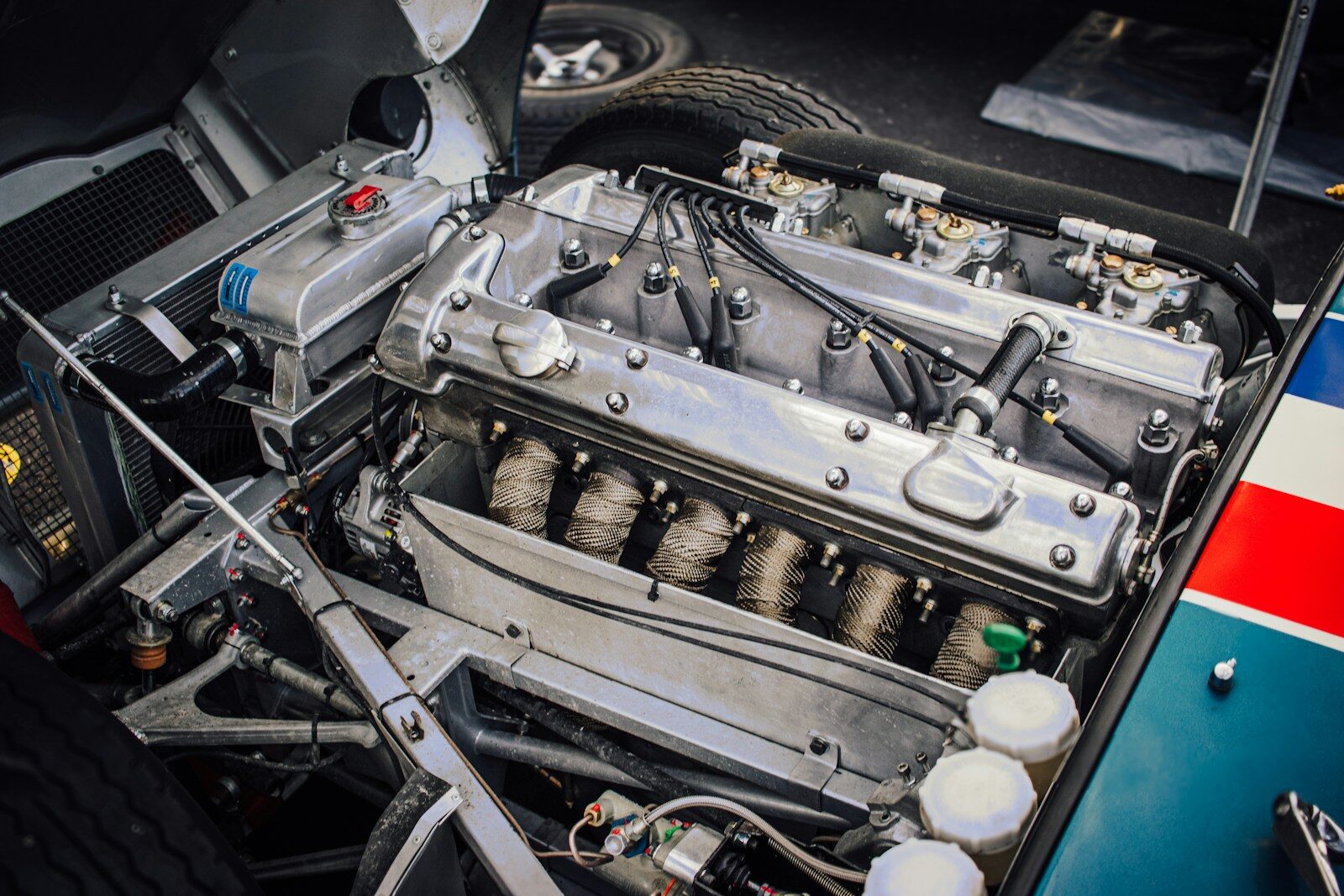 Classic car engine with polished metal components and carburetors