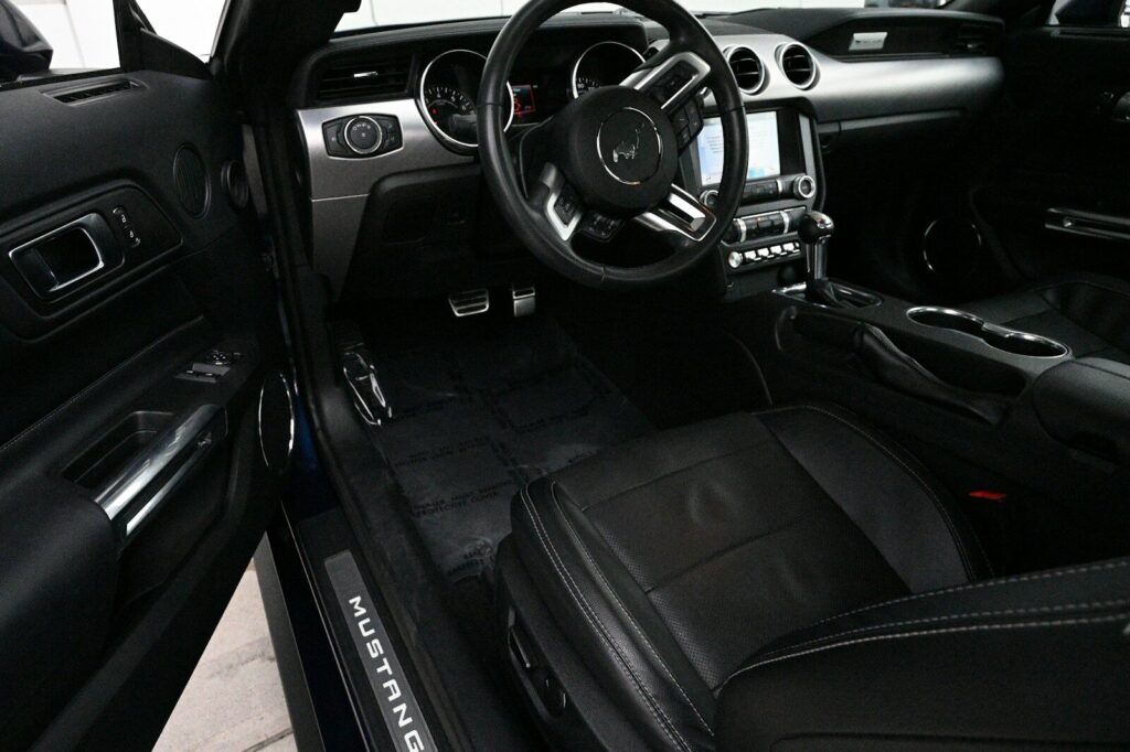 the interior of a car with black leather seats