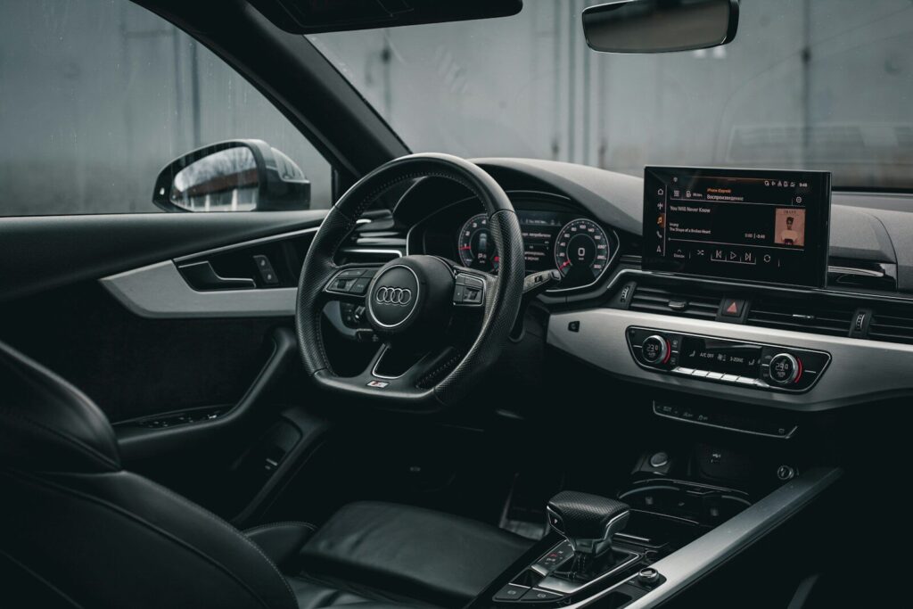 the interior of a car with a steering wheel and dashboard