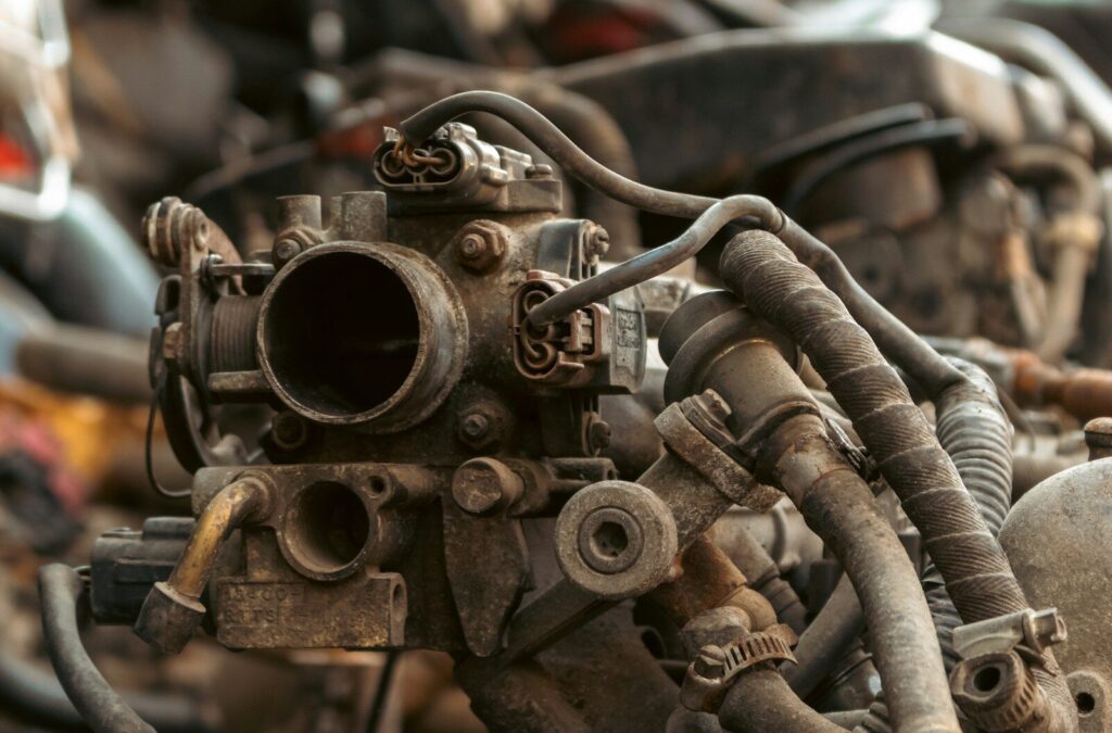 Close-up of a rusty old car engine carburetor