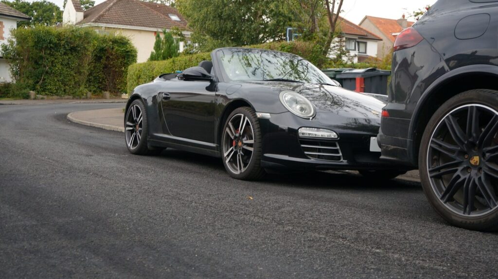 A black convertible sports car parked on street