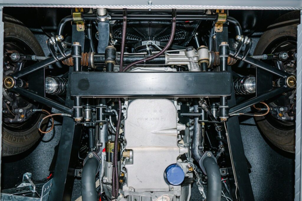 Underside view of a complex car engine and suspension.