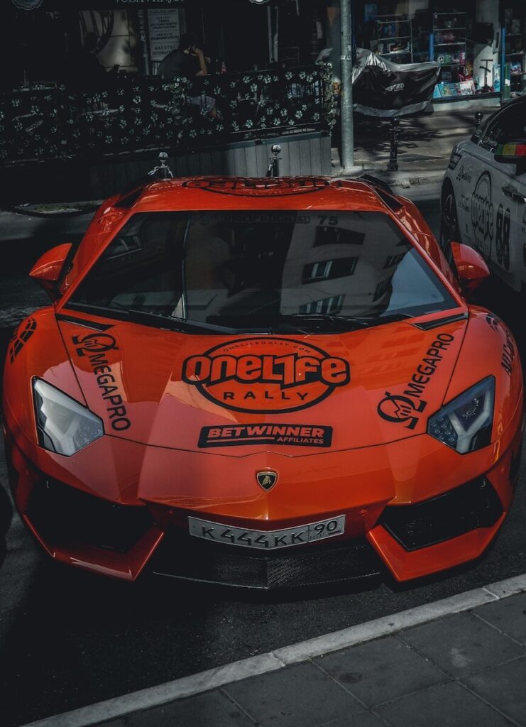 a red sports car parked on the side of the road