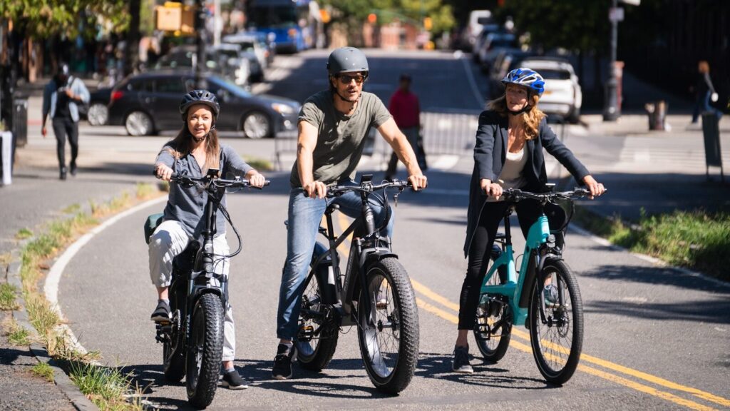 a group of people riding bikes on a street