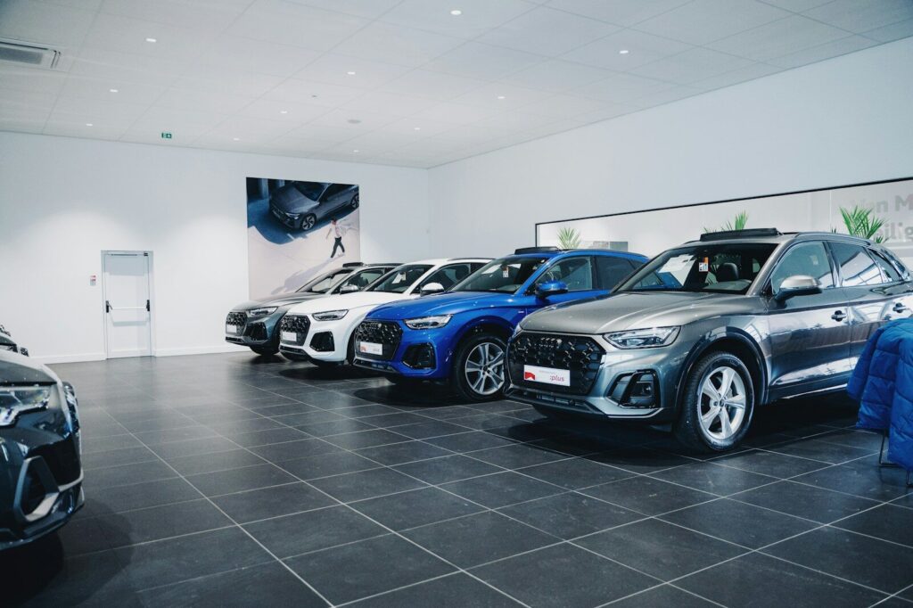 Cars are lined up in a showroom.