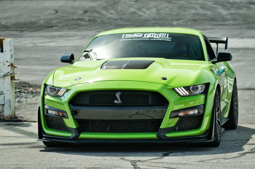A bright green sports car with a spoiler