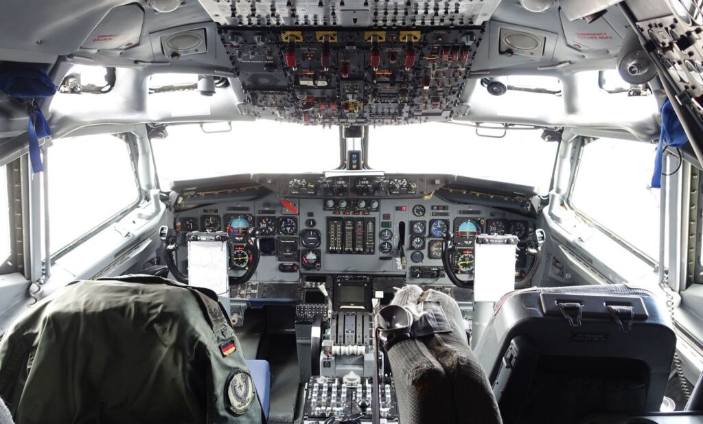 Explore the intricate aircraft cockpit, showcasing aviation controls and design.