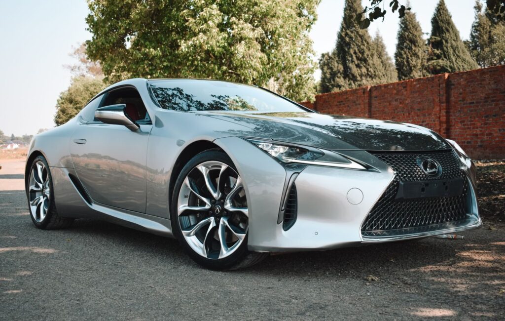 Sleek silver Lexus sports car parked outdoors on a sunny day, showcasing luxury and modern design.