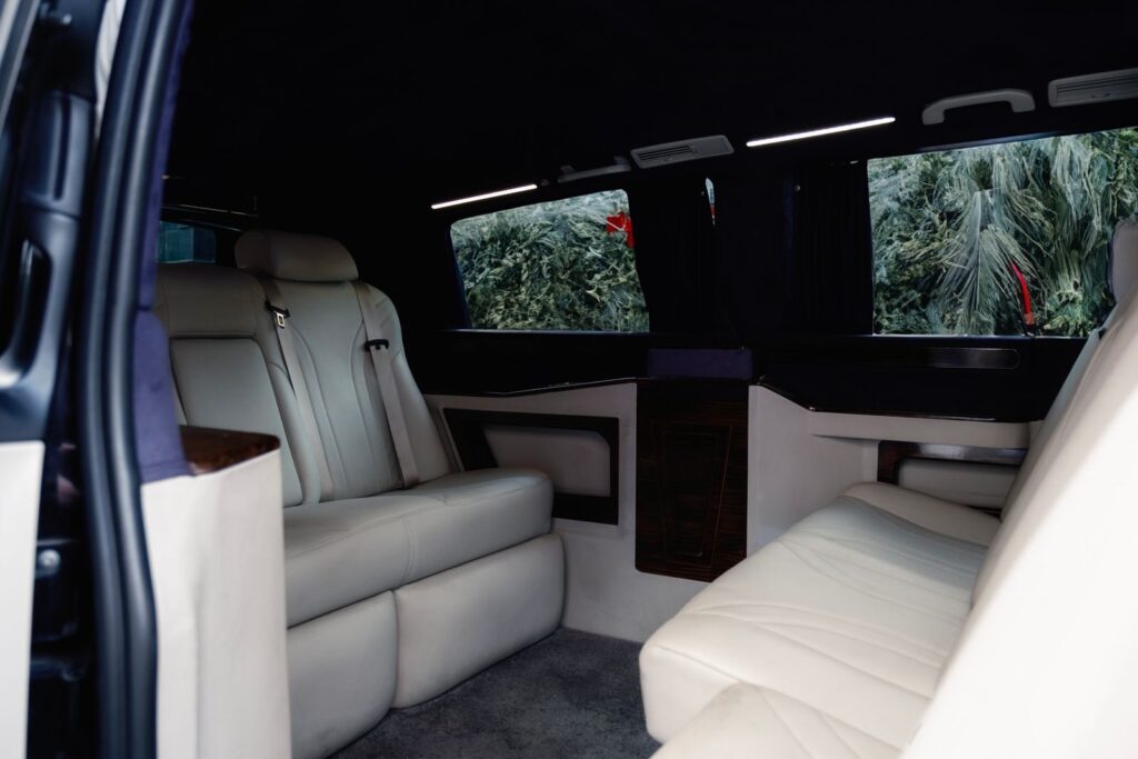 Spacious and comfortable leather seating inside a modern luxury van, perfect for travel.