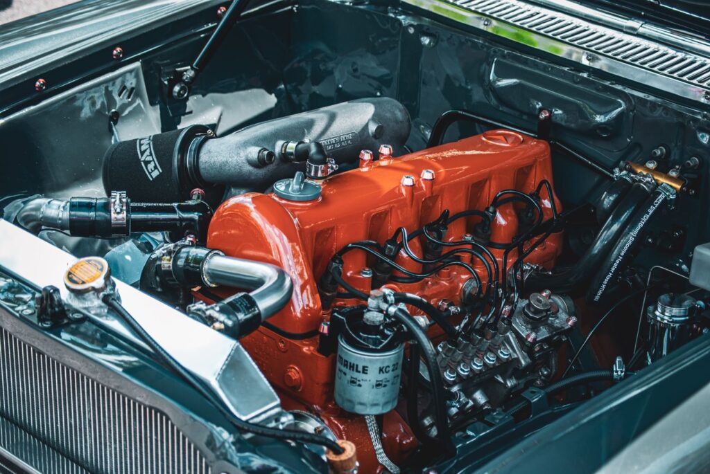 Detailed view of a vibrant engine in a classic car, showcasing retro mechanics.