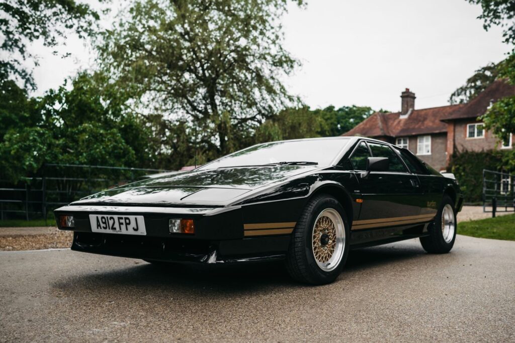 Classic black Lotus Esprit parked in a residential London area, showcasing vintage car elegance.
