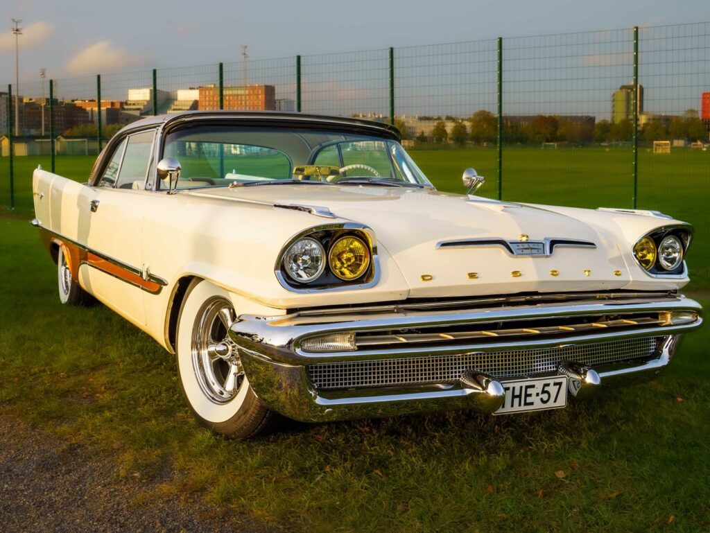 A classic Desoto car parked outdoors in Turku, Finland, during sunset.