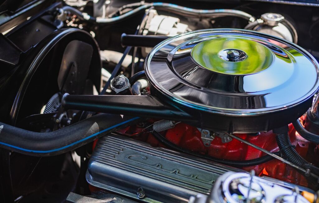 Detailed view of a classic car engine, highlighting parts and mechanics.