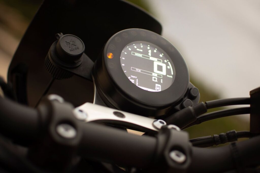 Close-up view of a digital motorcycle speedometer showing detailed indicators.