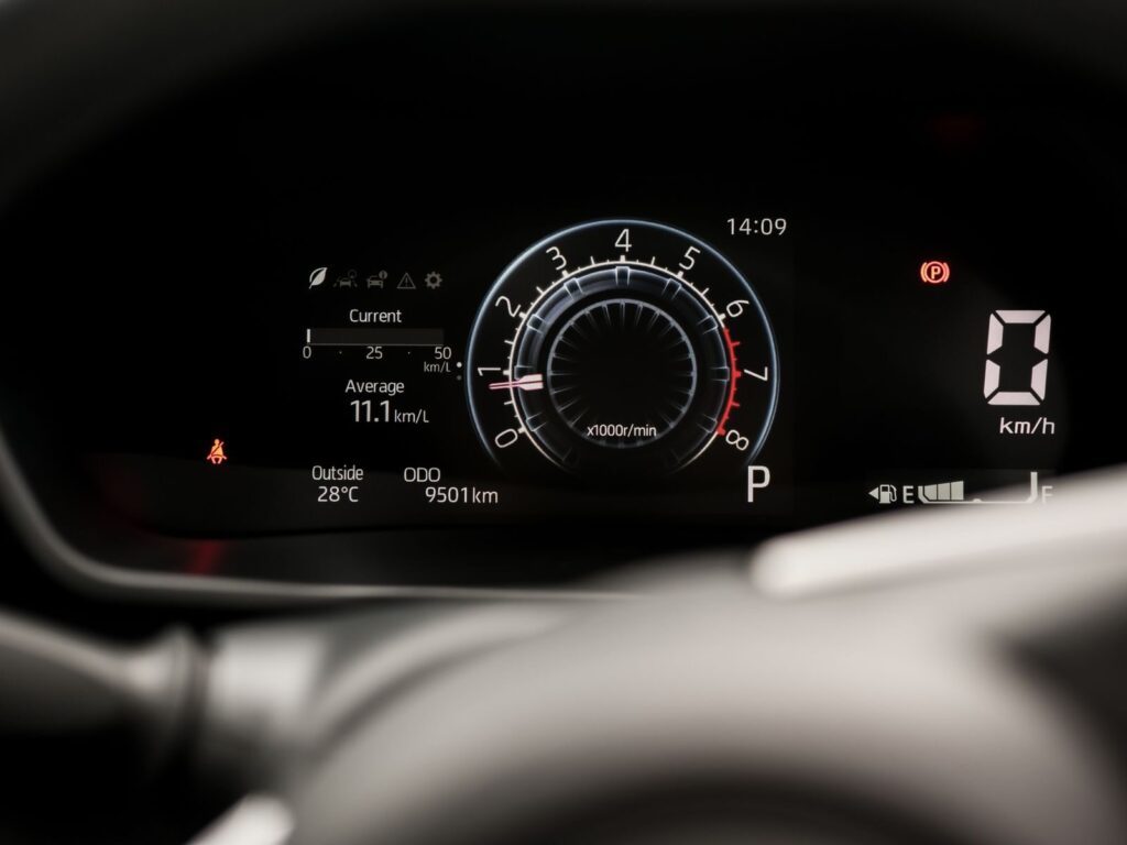 Detailed view of a car's digital dashboard display showing speed, tachometer, and indicators.