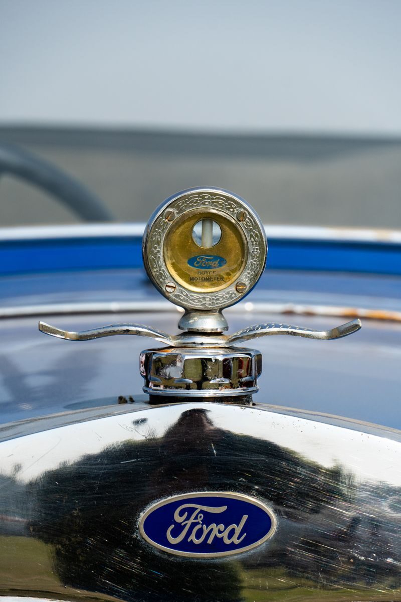 Close-up image of a vintage Ford radiator cap with classic design details.