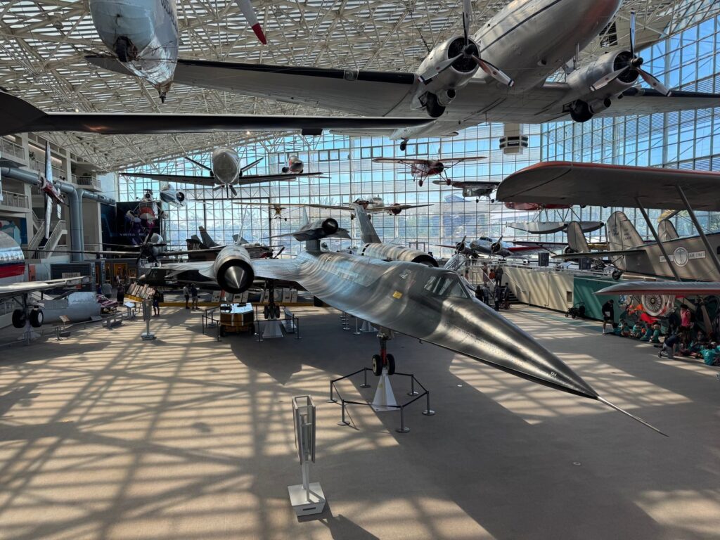 Explore a diverse collection of historic aircrafts showcased in a spacious aviation museum.