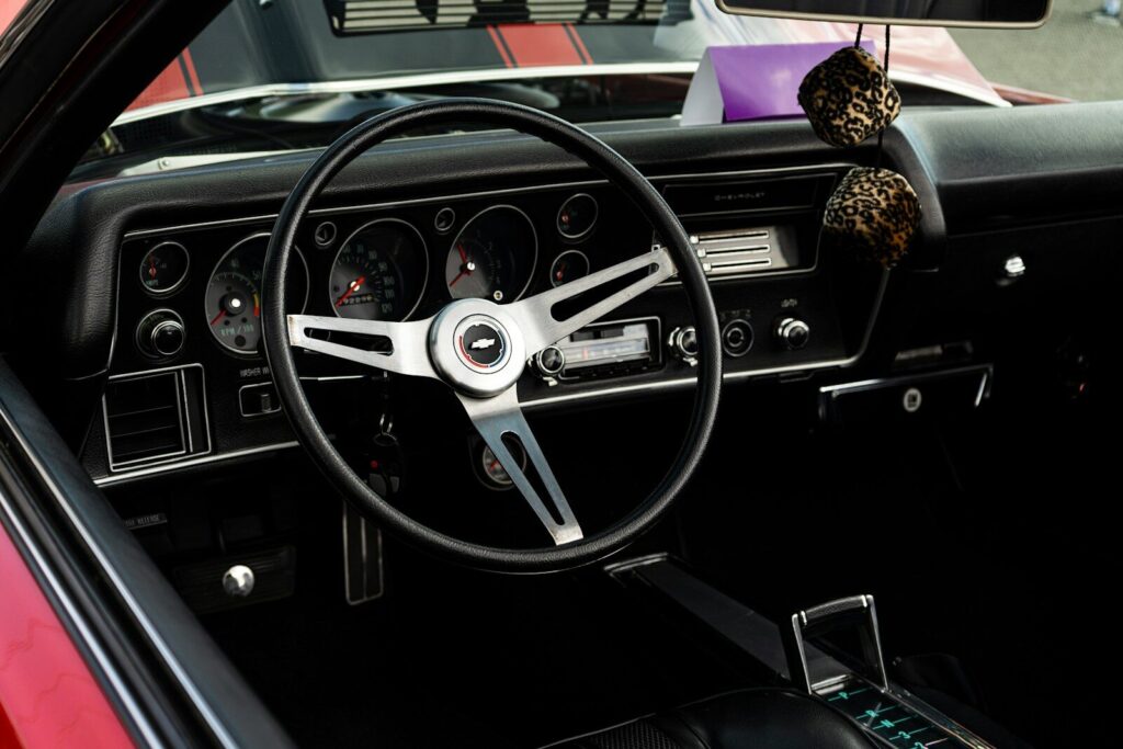 Interior view of a vintage car dashboard and steering wheel