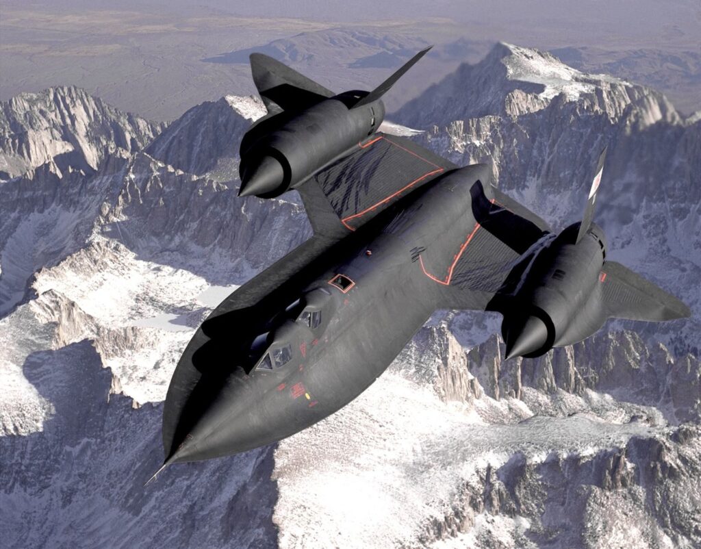 Lockheed SR-71 Blackbird flying over a snowy mountain range, showcasing advanced military aviation.