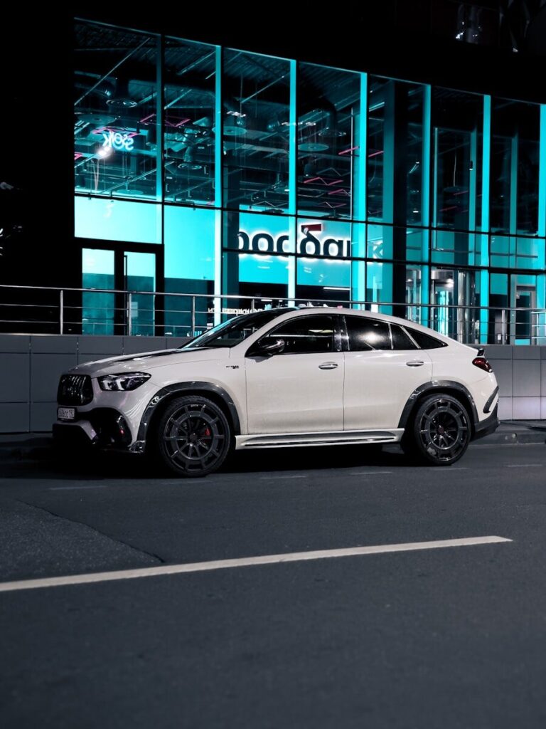 A white car parked in front of a building