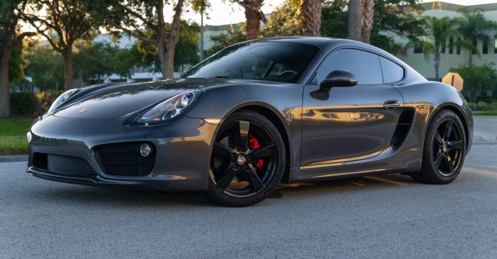 a grey sports car parked in a parking lot