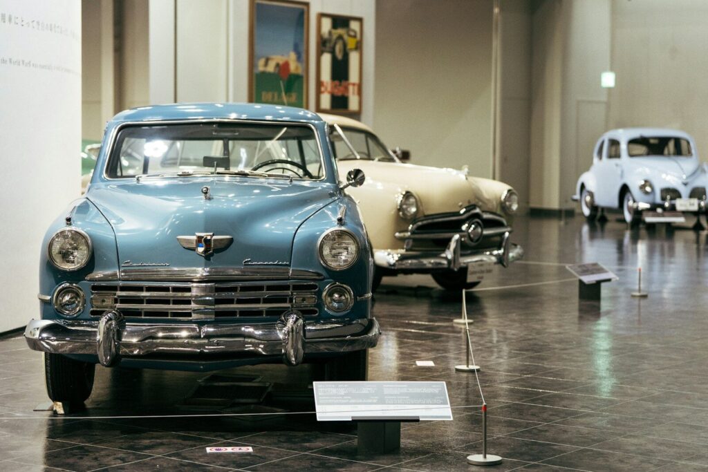 Vintage cars displayed in a museum exhibition hall