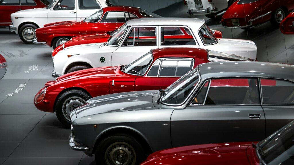 A bunch of cars are parked in a garage