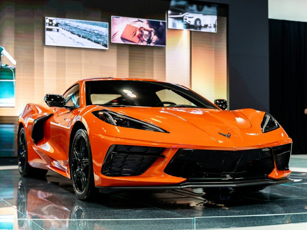 orange lamborghini aventador parked in front of white building