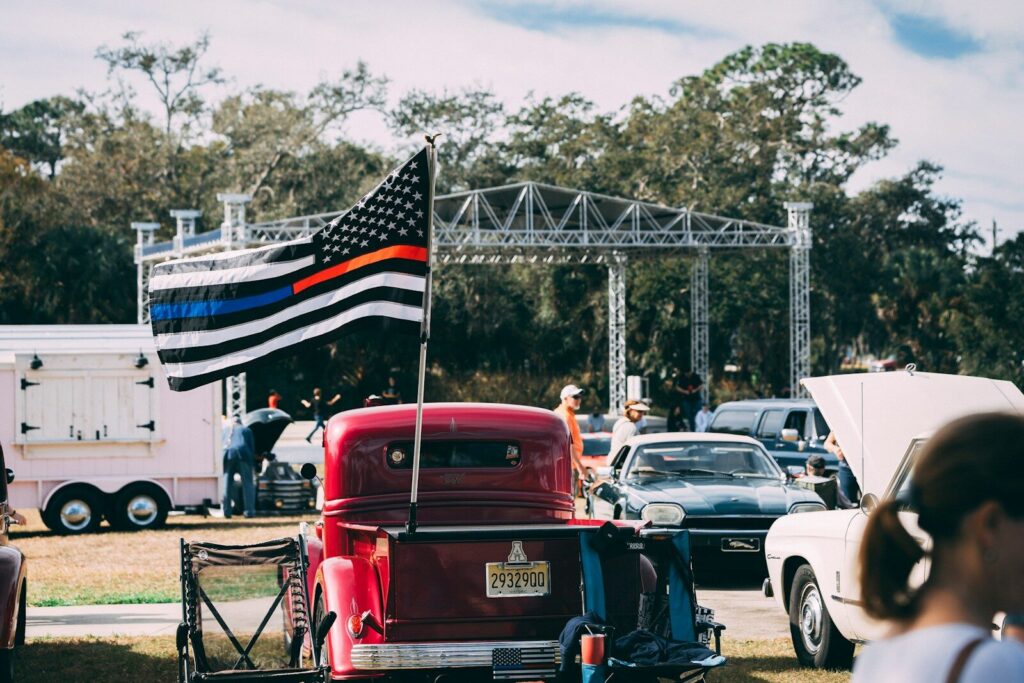 Classic cars and american flag at outdoor event