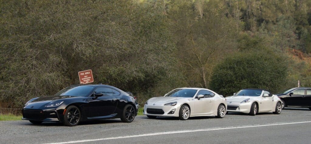 three cars parked on the side of the road