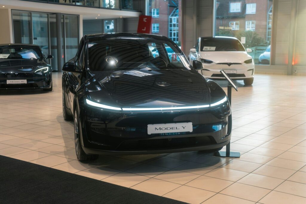 A couple of cars are parked inside of a building